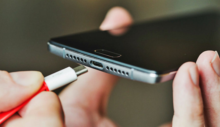 person putting a phone on charge