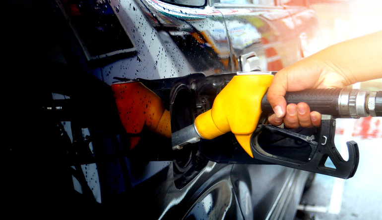 Person filling up a car with petrol