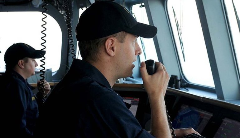 Man speaking to the radio in a ship