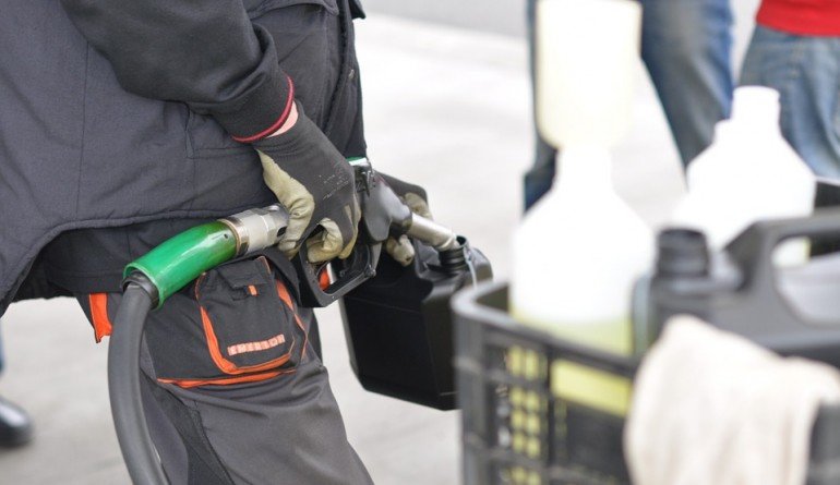 Man filling up jerrycan with petrol