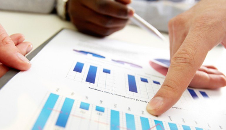 Fingers pointing to a graph