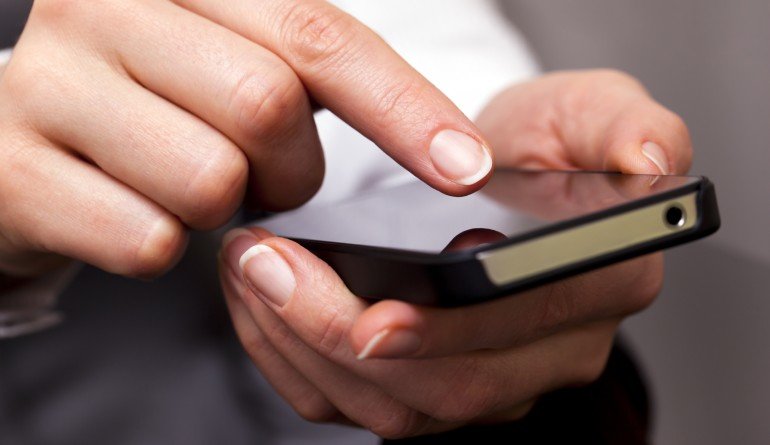 Person typing on phone