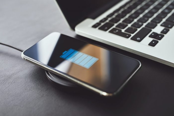 Phone being charged next to laptop