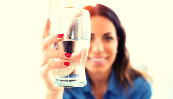 Woman holding a glass of water