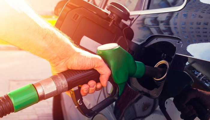 Person filling up a car with petrol