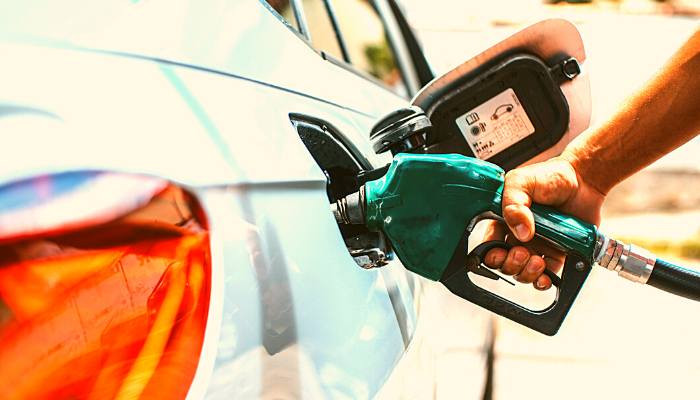 Person filling up a car with petrol