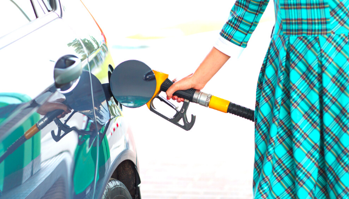 Person filling up a car with petrol