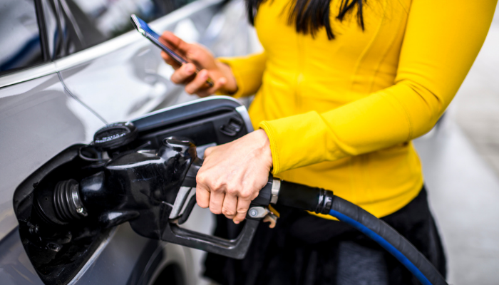 Person filling up a car with petrol