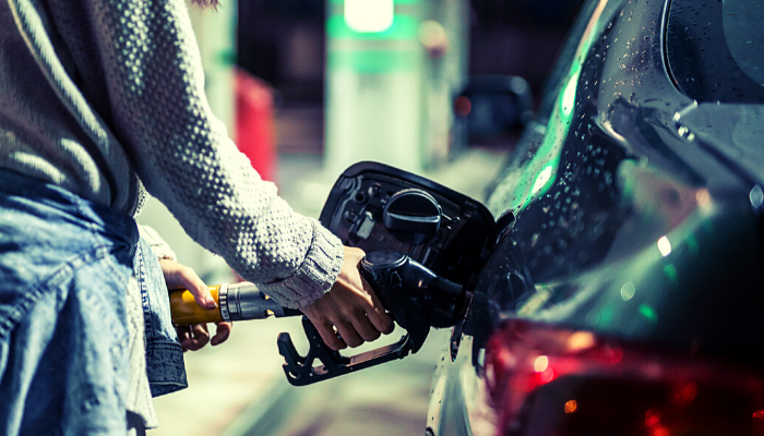 Person filling up a car with petrol